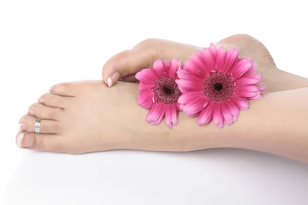 Frau Füße Beine und Blumen auf weißem Hintergrund — Stockfoto