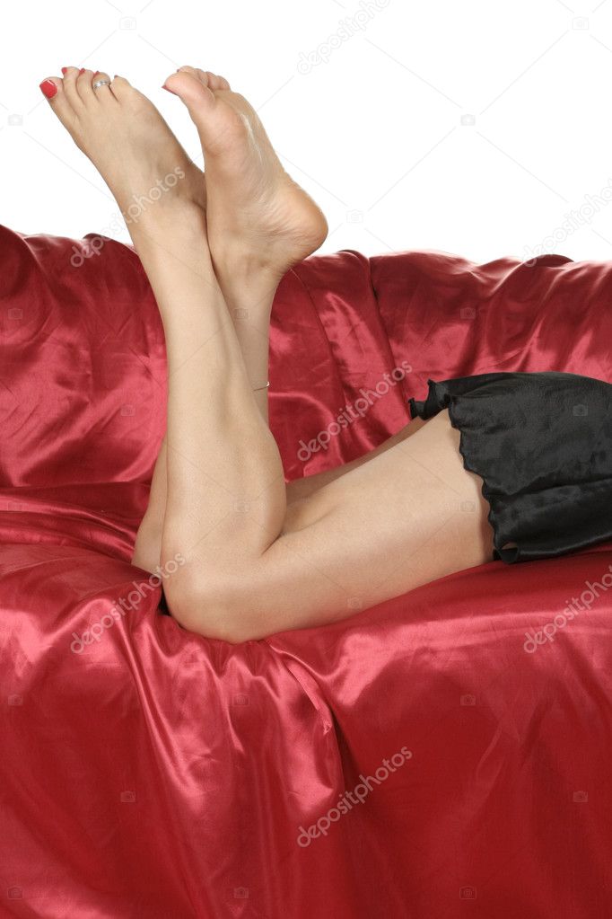 Woman legs with black nightie isolated over red