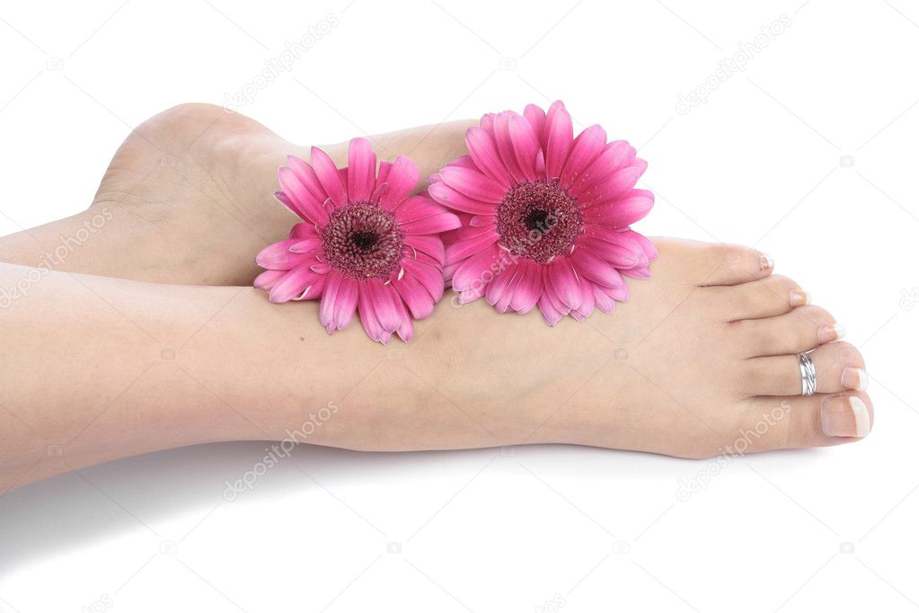 Woman feet legs and flowers over white