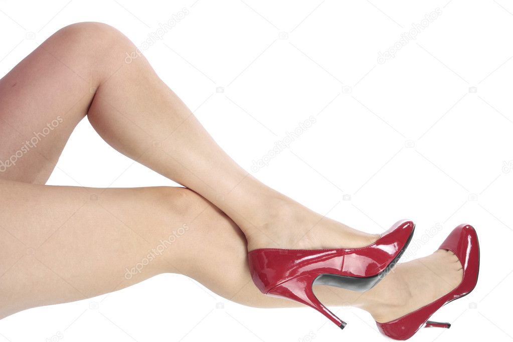 Woman feet wearing red heel shoes over white background