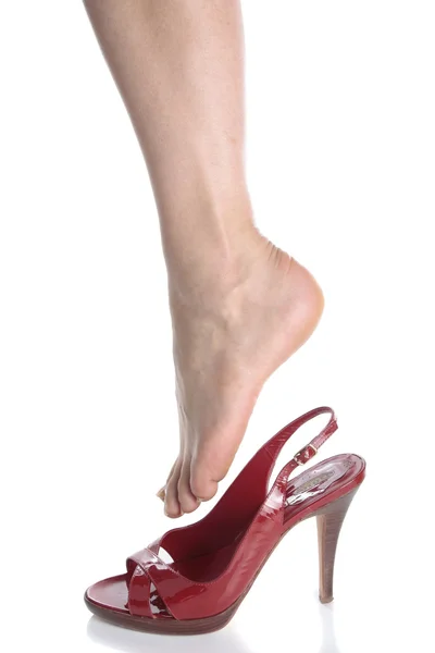 Beautiful woman legs and red heel shoes over white — Stock Photo, Image