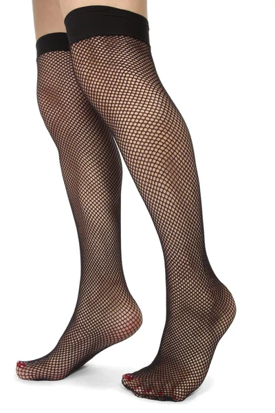 Donna piedi con calze a rete su sfondo bianco — Foto Stock