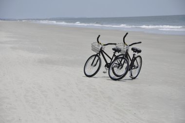 Two bikes on beach clipart