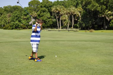 Young boy golfing clipart