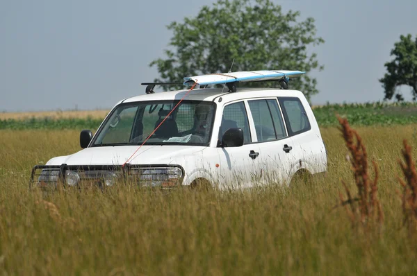 Terrain vehicle in high grass — Stock Photo, Image