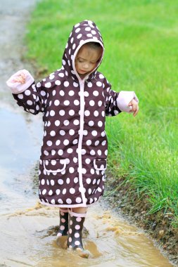 Child Playing in Rain clipart