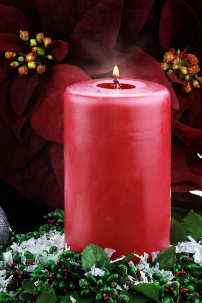 Lit Christmas Candle and Poinsettias — Stock Photo, Image