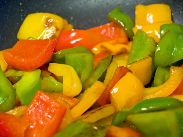 stock image Frying red, green and yellow bell peppers