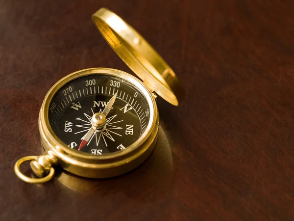 stock image Brass Compass on an old cherrywood table