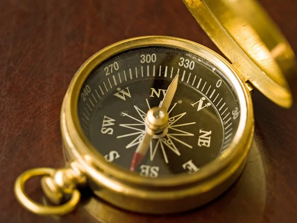 stock image Brass Compass on an old cherrywood table