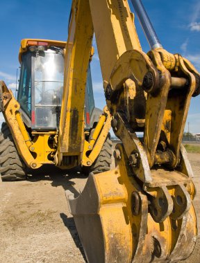 Heavy Duty construction equipment parked at work site clipart