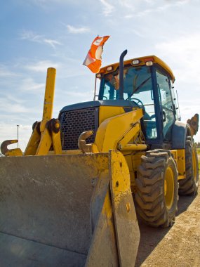 Bulldozer Construction Equipment parked at work site clipart