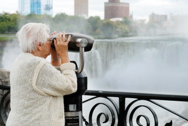 Elderly woman looking at american falls clipart