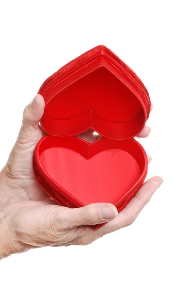 Starší žena ruce červené srdce — Stock fotografie
