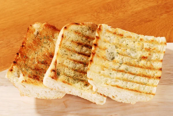 Garlic bread with cutting board — Stock Photo, Image