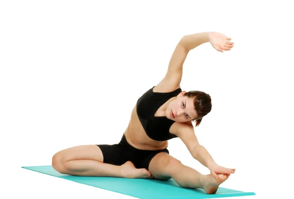 Young brunette woman doing stretches — Stock Photo, Image