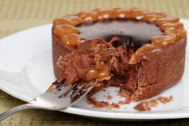 Chocolate toffee caramel cake on a fork clipart