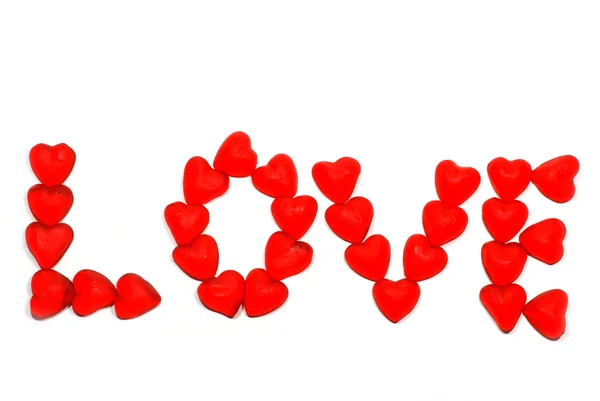Godis hjärtan stavning ordet kärlek — Stockfoto