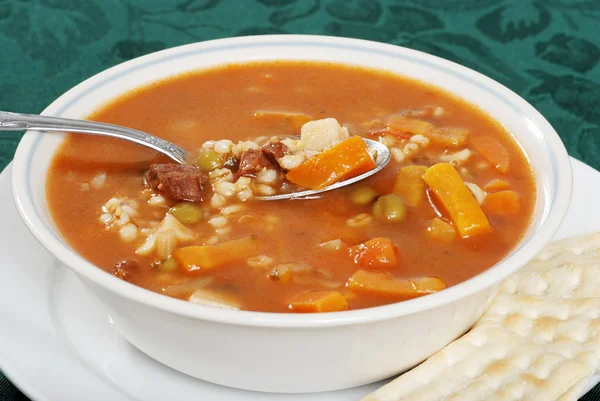 Closeup beef barley soup with a spoonful — Stock Photo, Image