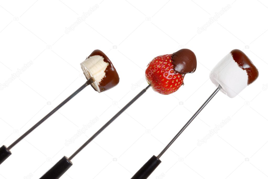 Chocolate covered food on fondue stick