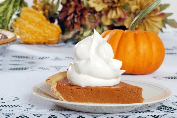 Whip cream loaded on pumpkin pie — Stock Photo, Image