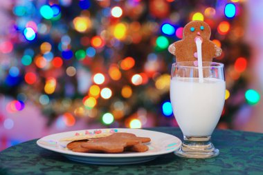 Gingerbread man drinking santa claus milk clipart