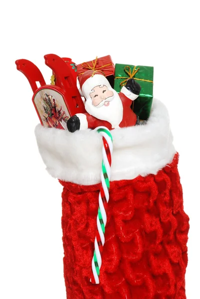 Рождественский носок с игрушками крупным планом — стоковое фото
