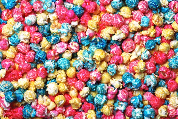 Kleurrijke snoep popcorn maken een achtergrond — Stockfoto
