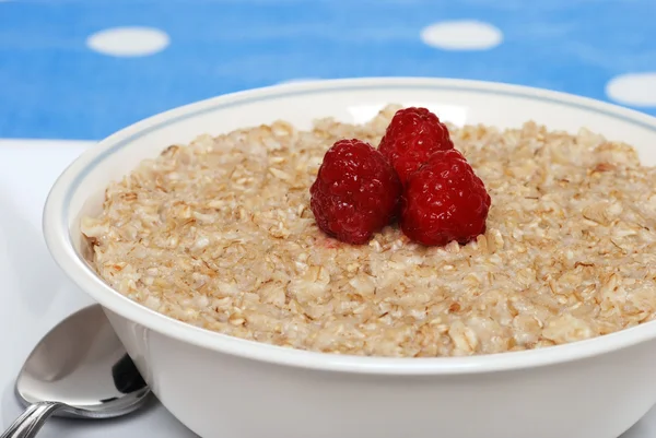 Closeup oatmeal with raspberries focus on berries — Stok fotoğraf