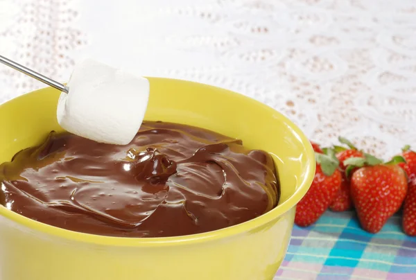 Marshmallow dipping in chocolate fondue — Stock Photo, Image