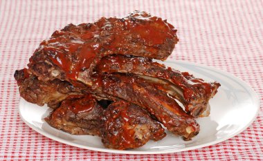 Stack of barbecue beef spare ribs with sauce clipart