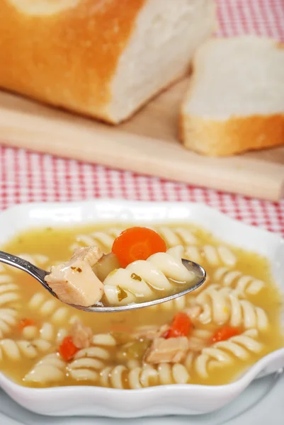 Spoonful of chicken pasta soup — Stock Photo, Image
