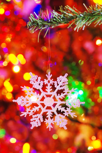Snowflake on a fake spruce branch — Stock Photo, Image