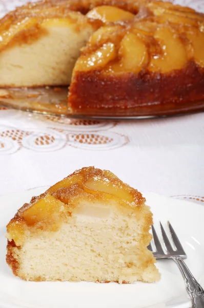 Upside down pear cake with more in the background — Stock Photo, Image