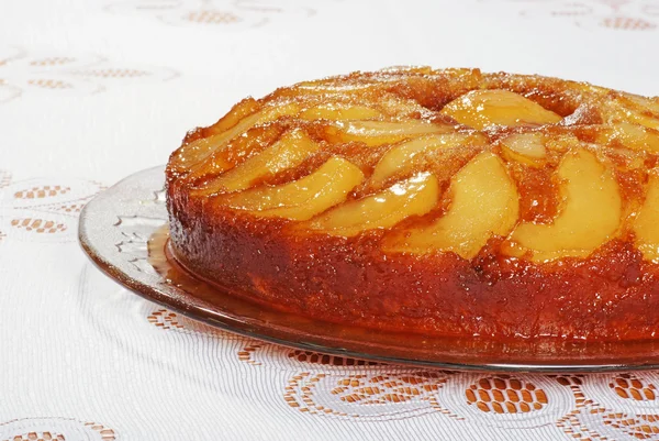 Upside down pear cake on glass plate — Stock Photo, Image