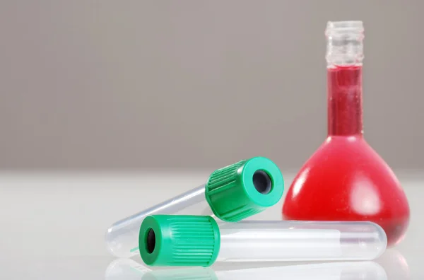stock image Test tube with red flask