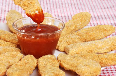 Closeup BBQ sauce with chicken fingers clipart