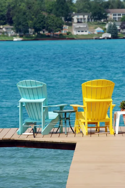 Adirondack chairs on a dock — Stock Photo, Image