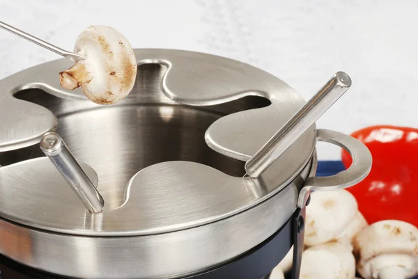 Cooking mushroom in oil fondue — Stock Photo, Image