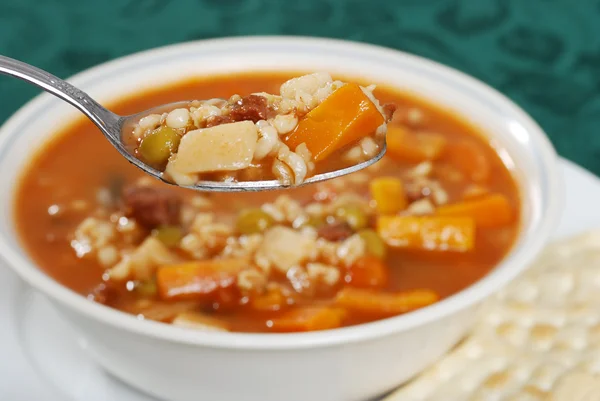 Macro beef barley soup in a spoon — Stock Photo, Image