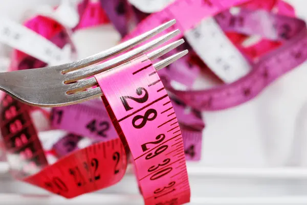 Macro pink tape measure on fork — Stock Photo, Image