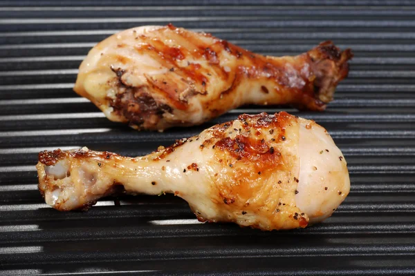Chicken drumstick on grill — Stock Photo, Image