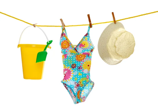 Girls beach wear and toys on clothes line — Stock Photo, Image