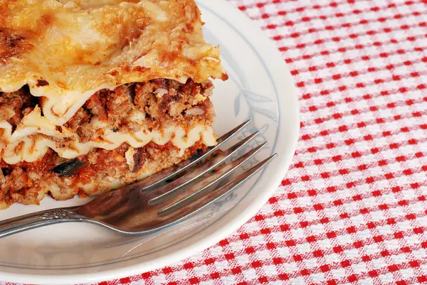 Lasagna closeup with a fork — Stock Photo, Image
