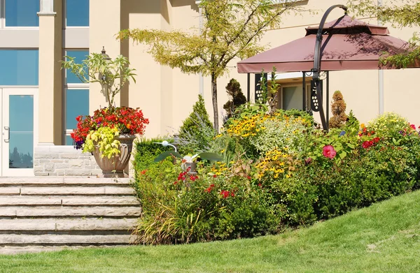 Stock image Outdoor patio with formal flower garden