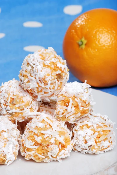 stock image Orange snowball cookies with fruit in the background