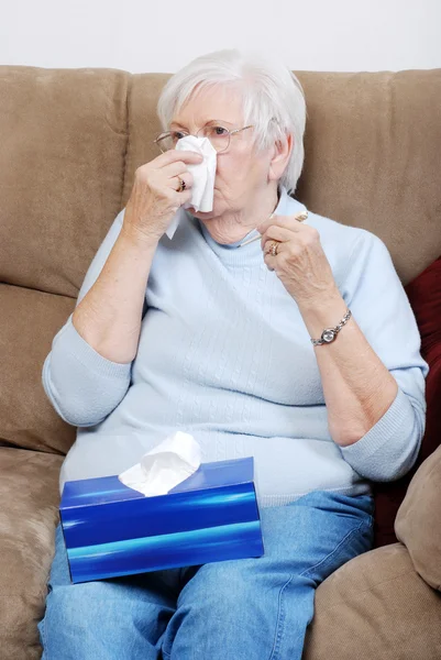 Sick senior woman blowing her nose — Stock Photo, Image
