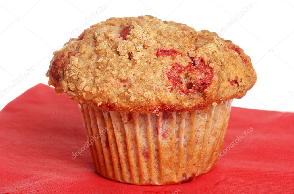Raspberry whole wheat muffin on red napkin