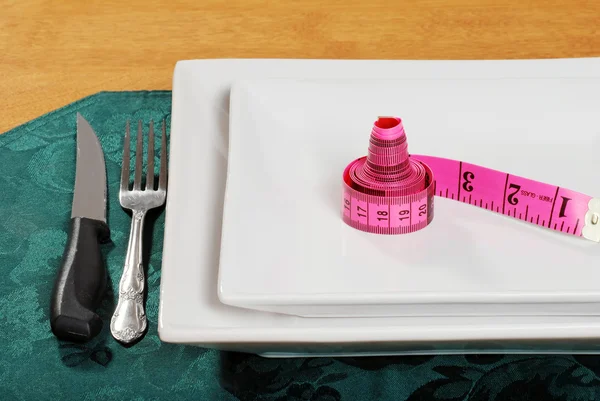 Pink tape measure on a plate — Stock Photo, Image