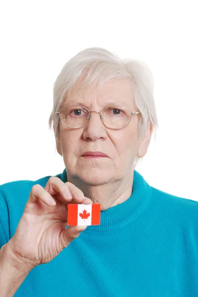 Donna anziana che tiene Canada giorno bandiera adesivo concentrarsi sul viso — Foto Stock